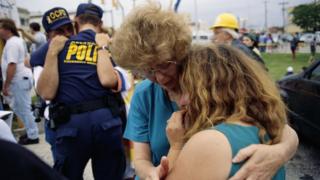 Family members of those lost in the Oklahoma City bombing grieve as they watch the remains of the Alfred P. Murrah building be demolished