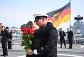 Petty officer first class Antonio Weber is kissed by his girl friend Laura aboard the Bundeswehr Navy frigate Hessen.