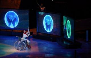 A performer in a wheelchair performs at the closing ceremony