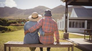 An older couple sitting on a bench