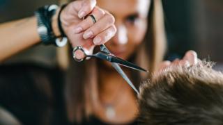 A woman cutting hair