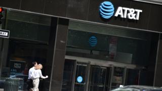 People walk by an AT&T store in New York City, on May 11, 2018.