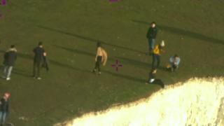 People near the edge of the cliffs at Beachy Head