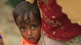 Two-year-old Hazera, confused and scared, holds on to her mother after reaching Bangladesh from Myanmar
