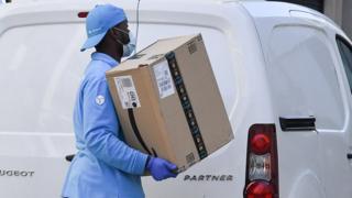 Amazon delivery worker in mask and gloves