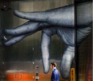 A man walks past street art in New York, USA. 19 September 2019.