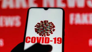 Phone screen with Covid-19 symbol showing