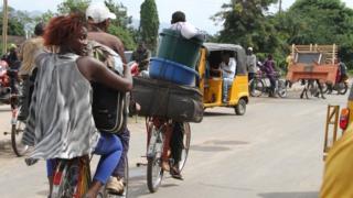 Bujumbura residents carry their belongings as they leave the city. Photo: 7 November 2015