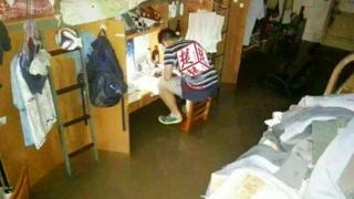 Photo of a Chinese student studying in floodwaters in Wuhan, taken from Weibo