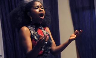 Nigerian soprano Omo Bello rehearses in Lagos on December 8, 2017. A live performance of an aria from an Italian opera, sung by a professional soprano, isn"t a common sound in Nigeria"s bustling commercial and entertainment capital. But it"s not the strangest thing for the performer, Omo Bello. News of her appearance in Lagos has attracted a crowd, even it"s only for a short rehearsal.
