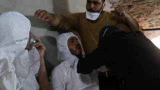 A man breathes through an oxygen mask as another one receives treatments, after what rescue workers described as a suspected gas attack in the town of Khan Sheikhoun in rebel-held Idlib, Syria April 4, 2017.