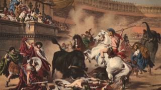 gladiadores montados en elefantes y caballos en un anfiteatro romano.