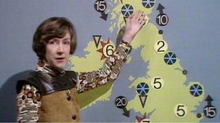 Barbara Edwards, gesturing to a weather map