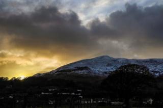 Snow on a hill at sunset