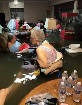 Residents of La Vita Bella assisted living facility are seen in waste-deep flooding due to Tropical Storm Harvey in Dickinson, Texas, 27 August 2017.