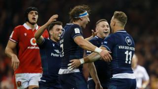 Scotland players celebrate as Dafydd Jenkins looks dejected