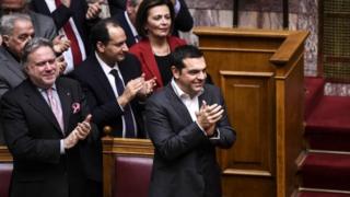 Greece's Prime Minister Alexis Tsipras celebrates after winning vote