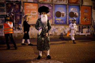 Children wear costumes and play during the Jewish holiday of Purim, in Ashdod, Israel. 9 March 2020