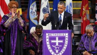 : Президент США Барак Обама выступает с речью для сенатора штата Южная Каролина и преподобного Клементы Пинкни во время похоронной службы Пинкни 26 июня 2015 года в Чарльстоне, Южная Каролина