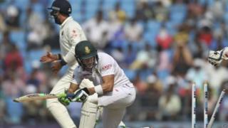 South African batsman Faf du Plessis looks back at his shattered stumps as he is bowled out by Indian spinner Amit Mishra, on the third day of the third cricket test match between the two countries in Nagpur, India, Friday, Nov. 27, 2015