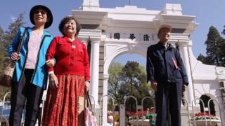 Alumni take photos in Tsinghua University in Beijing on April 24, 2011. Tsinghua University celebrates its centenary anniversary today. 24APR11 Photo by Simon Song