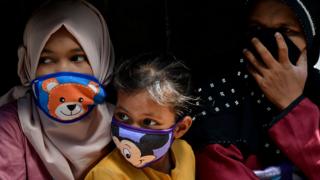 Family with masks on in Indonesia