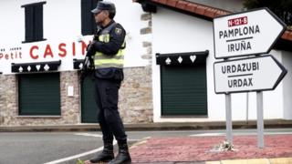 Spanish policeman stands guard at the Spanish side of the border crossing between Spain and France, close to the village of Dantxarinea, Navarra