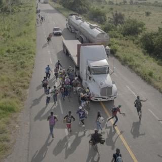 People are seen on a road