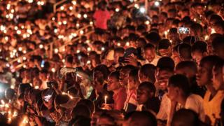 People hold candles as they attend a night vigil and prayer at the Amahoro Stadium as part of the 25th commemoration of the 1994 genocide in Kigali, Rwanda - Sunday 7 April 2019