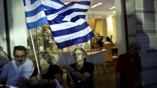 Supporters of the Greek Golden Dawn extreme right party wave the Greek national flag during a pre-election rally in Athens
