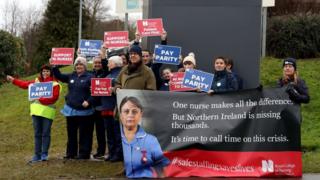 Nurses holding placards on a picket line