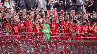 Liverpool players lift the FA Cup