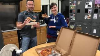 Staff in Portland, Maine enjoying pizza from counterparts across the border in Moncton, New Brunswick