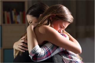 Mother and daughter embracing