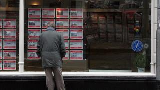 older man looking at an estate agency