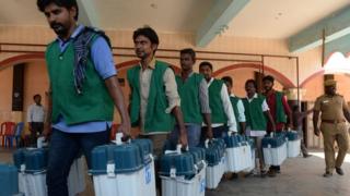 Indian election workers carry boxes containing Electronic Voting Machines (EVM) at a distribution point in Chennai on April 17, 2019, ahead of the second phase of India's general election.