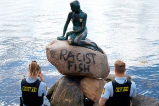 in_pictures Police take a photo of a statue of a mermaid with the words Racist Fish daubed on it