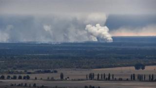 Smoke rises after an explosion in a weapons depot in Ukraine