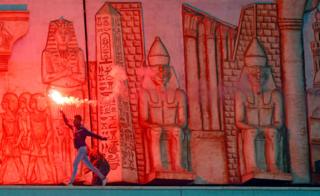 Egypt's Al Ahly v Gabon"s CF Mounana - Cairo International Stadium, Cairo, Egypt - March 6, 2018 - An Egypt's Al Ahly fan shouts slogans against the Interior Ministry whilst running with a flare during the game.
