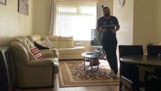 Asif Amirat running around his coffee table