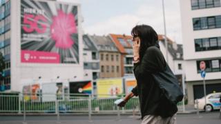 Woman in Cologne with phone