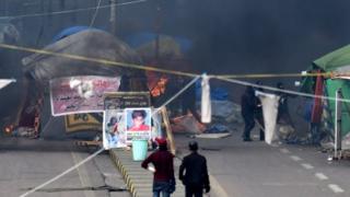 Iraqi security forces (in the background) burn protesters' tents at Tahrir Square in central Baghdad. photo: 25 January 2020