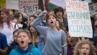 Schoolchildren march through Cambridge city centre to take part in a "die-in" climate change protest where they were campaigning against the use of fossil fuels.