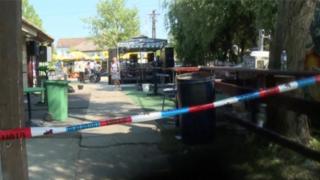 A police tape is seen in a cordoned area at a cafe after a shooting during a local festival in the village of Zitiste, north of Belgrade, Serbia in this still image from video taken 2 July2016.