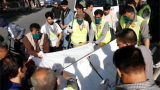 Afghan men carry an injured to a hospital after a blast in Kabul, Afghanistan September 9, 2020.