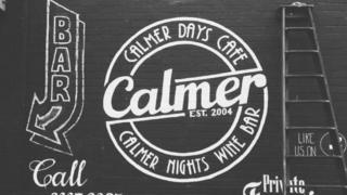 Cafe branding on the wall outside The Calmer Cafe