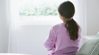 Girl sitting on bed