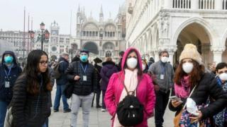 People wear masks in Venice, Italy. Photo: 25 February 2020