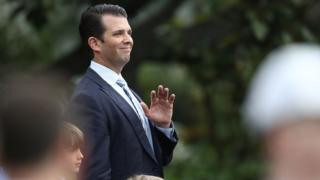 Donald Trump Jr waves at the White House