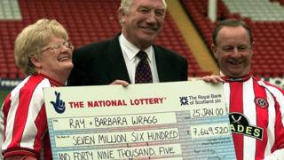 Ray and Barbara Wragg being presented with a cheque.